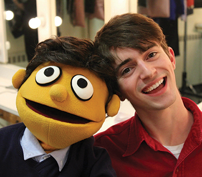 matthew with an avenue q puppet