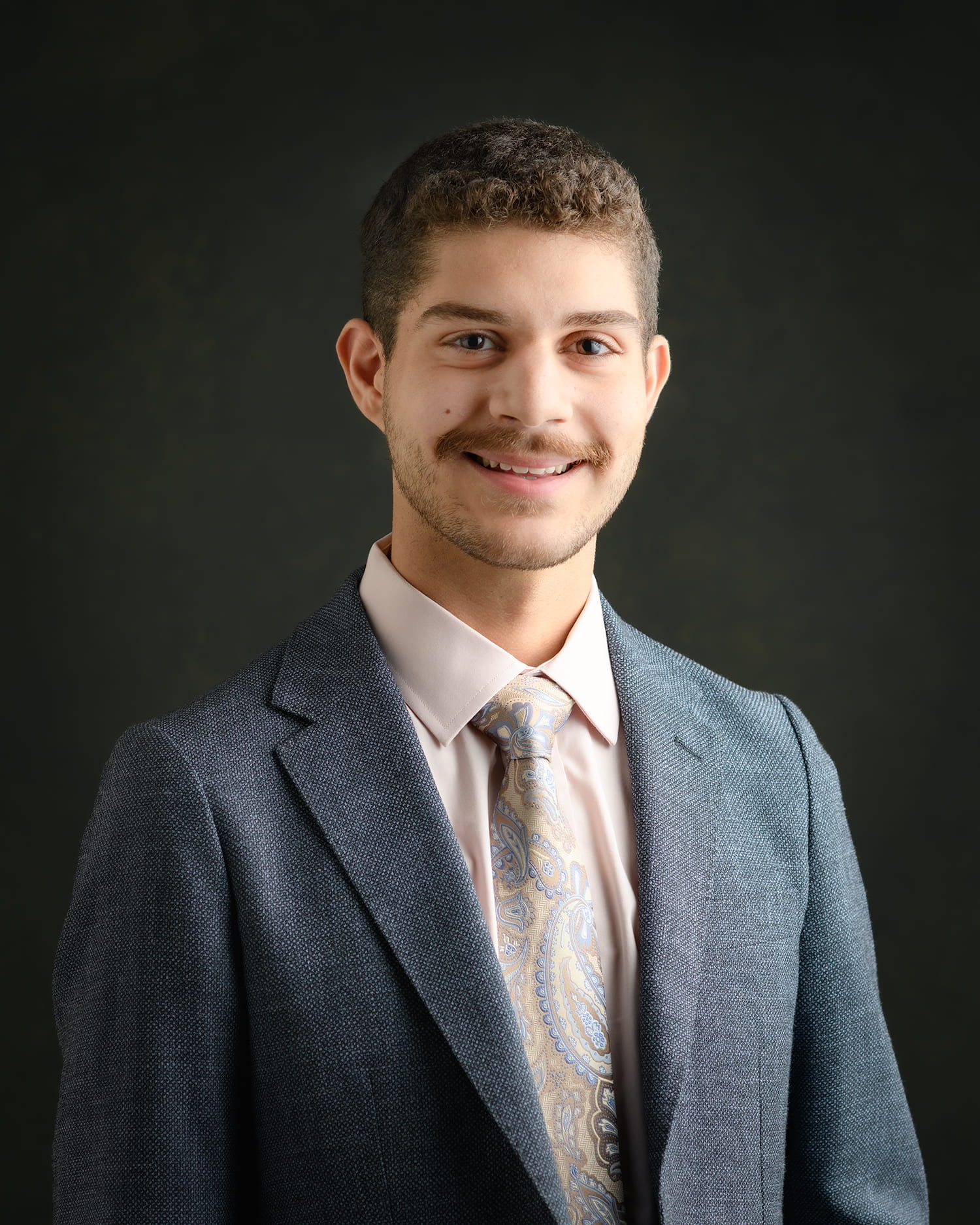 young man half length in a gray suit