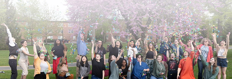 Art History students celebrating graduation in May 2024, by throwing confetti on Parker Quad.