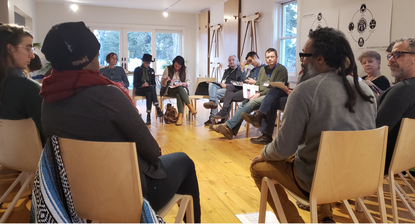 a group of people sitting in chairs on chairs talking