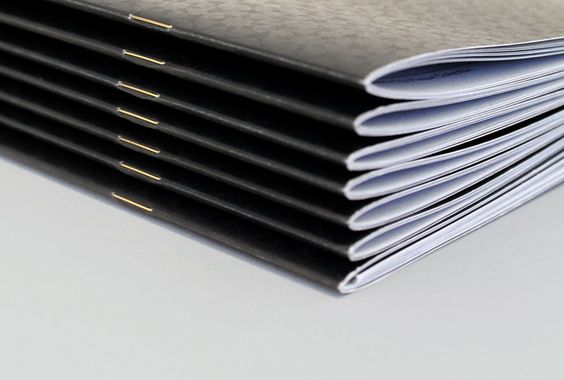 stack of saddle stitched booklets
