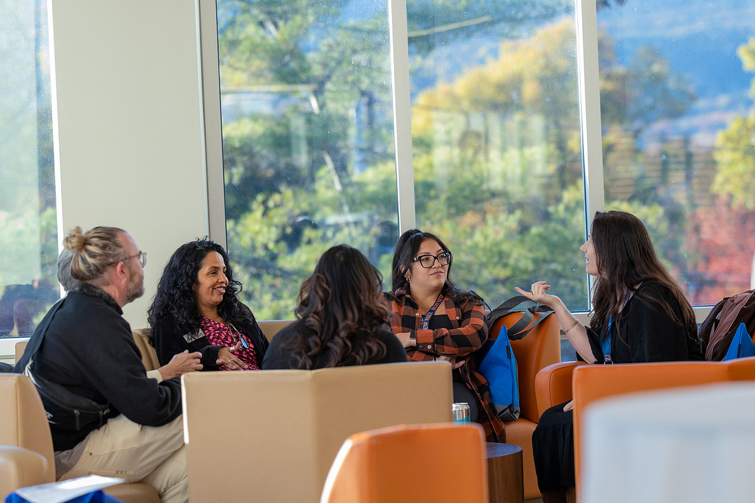 Alumni sitting down in chairs networking after an LA&S Panel.