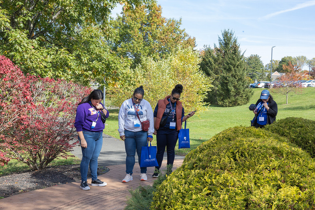 Alumni look at bricks in the Walk of Honor.