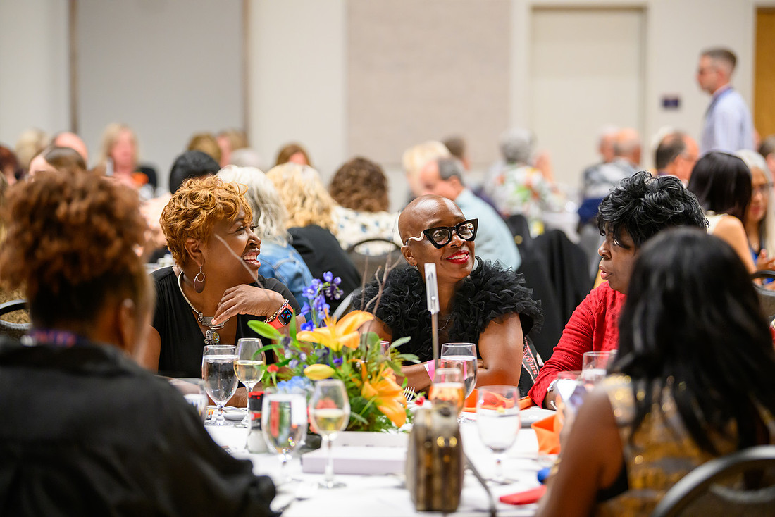 Awards ceremony dinner with folks sitting around a table.