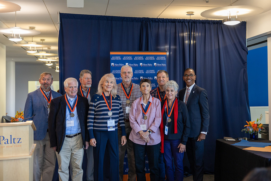 Awards ceremony recipients pose with their awards.