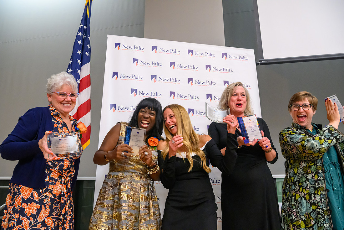 Awards ceremony recipients pose with their awards.