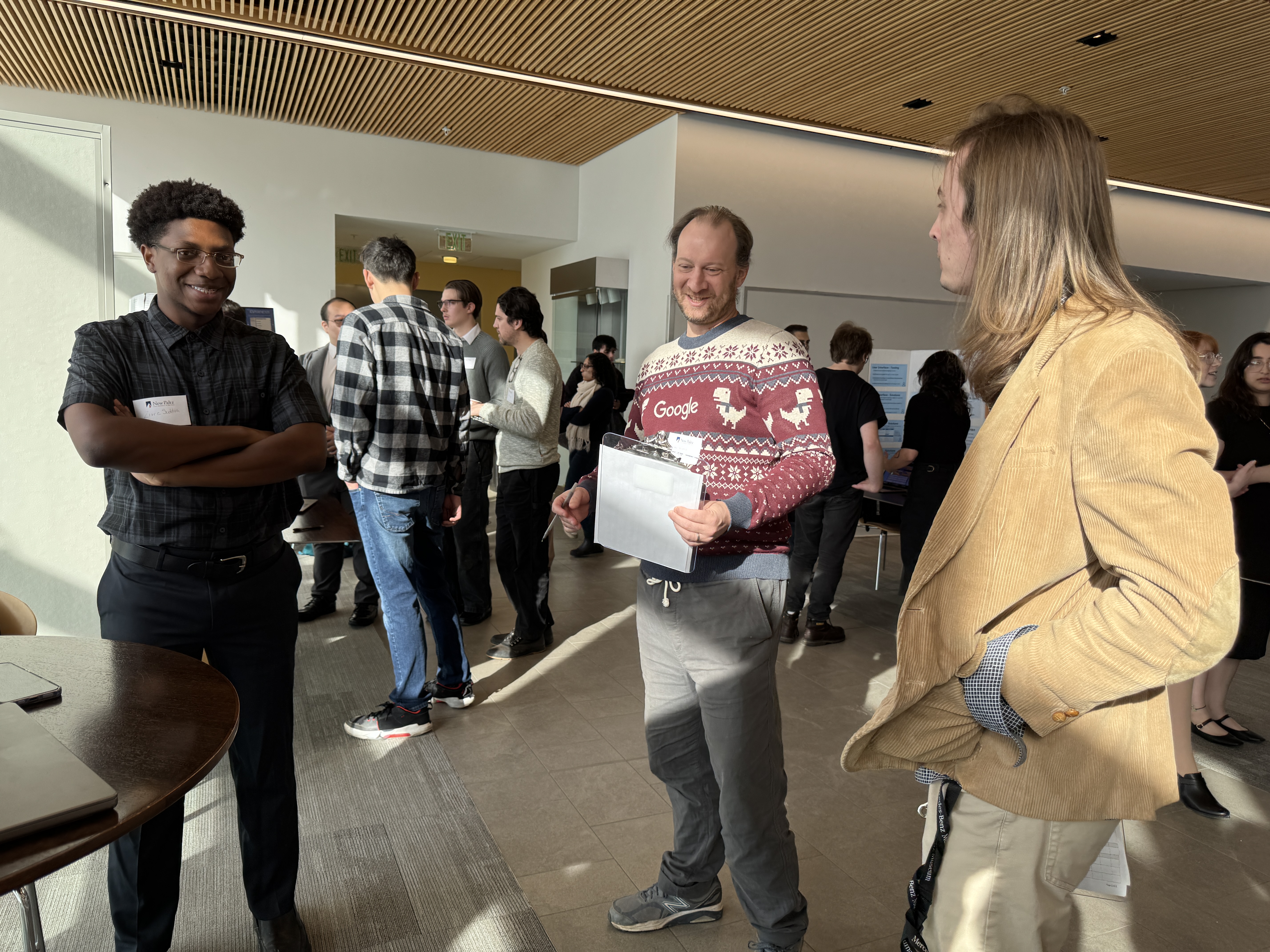 Alumnus visiting campus for Computer Science event in Google Christmas sweater